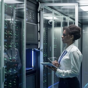 Technician standing near server racks